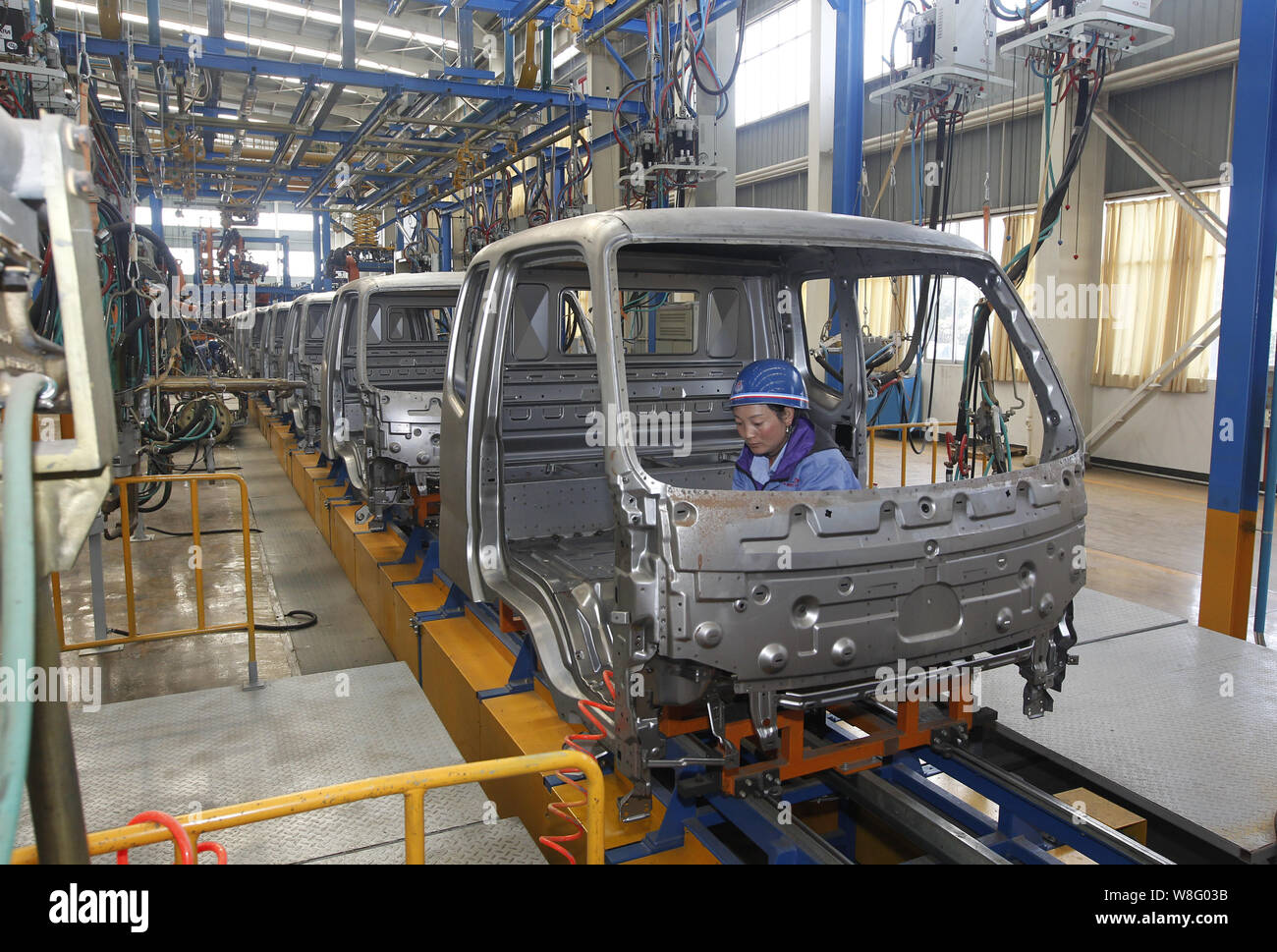 --FILE--A Chinese worker assembles a car on the assembly line at an ...