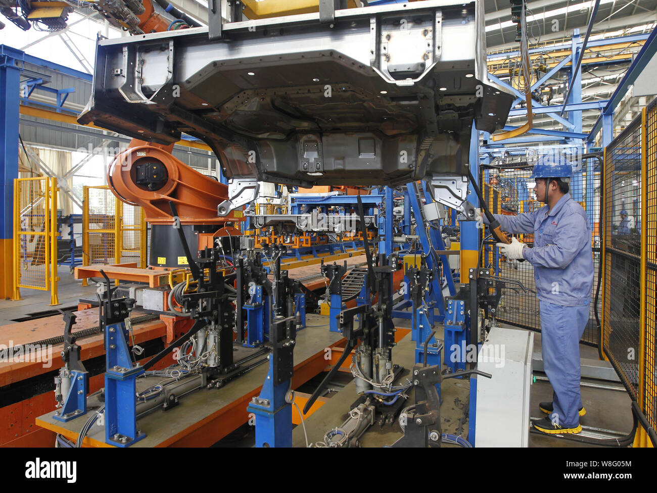 --FILE--A Chinese worker assembles a car on the assembly line at an ...