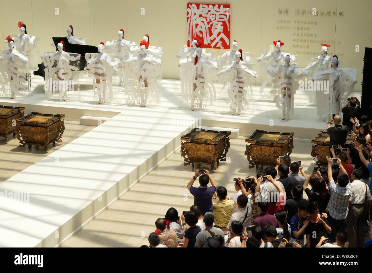 Models display creations of calligraphy during a fashion show at ...