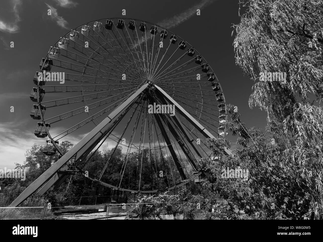 Abandoned ferris wheel in Spreepark, disused Berlin theme park from the GDR era Stock Photo