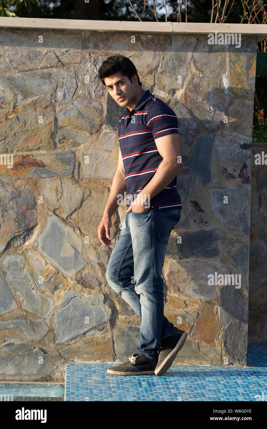 wallpapers Photoshoot Attitude Boys Pose Pic https www alamy com young man leaning against a stonewall image263424770 html