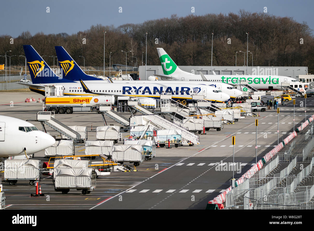 EINDHOVEN, THE NETHERLANDS - FEB 9, 2019: Low-budget airlines Ryanair and Transavia aircraft parked at the terminal of Eindhoven Airport. Stock Photo
