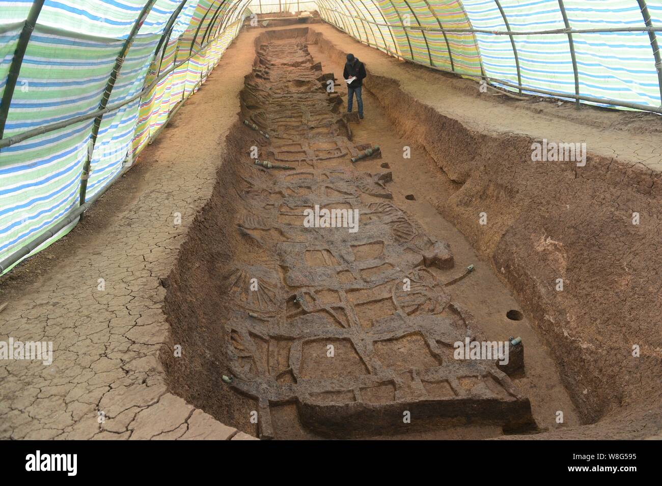 An archaeologist surveys the site of the earliest garage in China near a tomb dating back to either the Western Zhou Dynasty (1046 B.C.-771 B.C.) or t Stock Photo