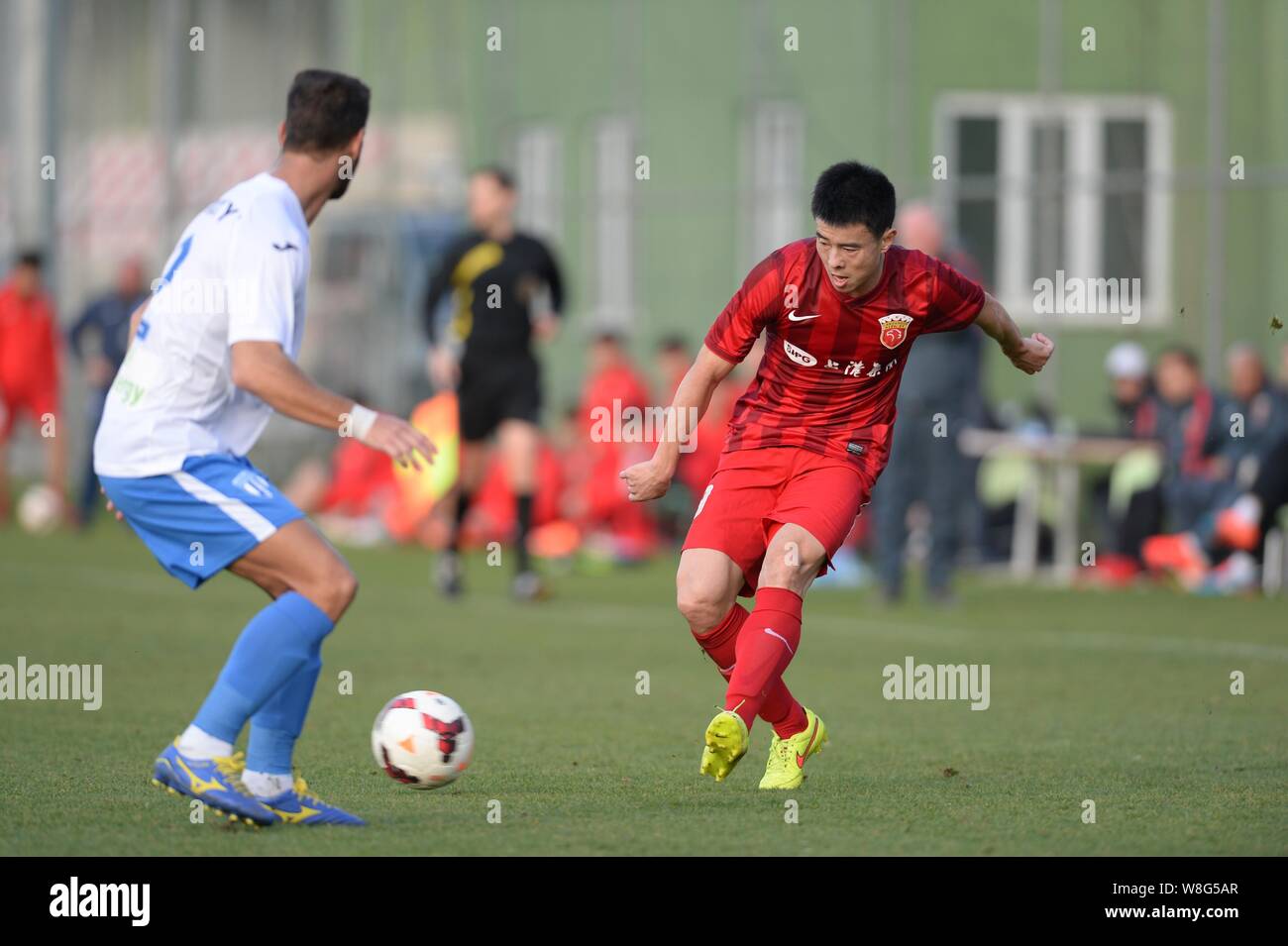Sun Xiang right of SIPG Football Club challenges a footballer of