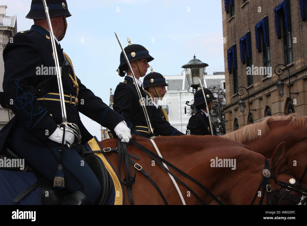 The soldiers on horses accompanying the Golden Coach with Queen Beatrix on Prinsjesdag annual presentation of Government Policy to the Parliament. Stock Photo