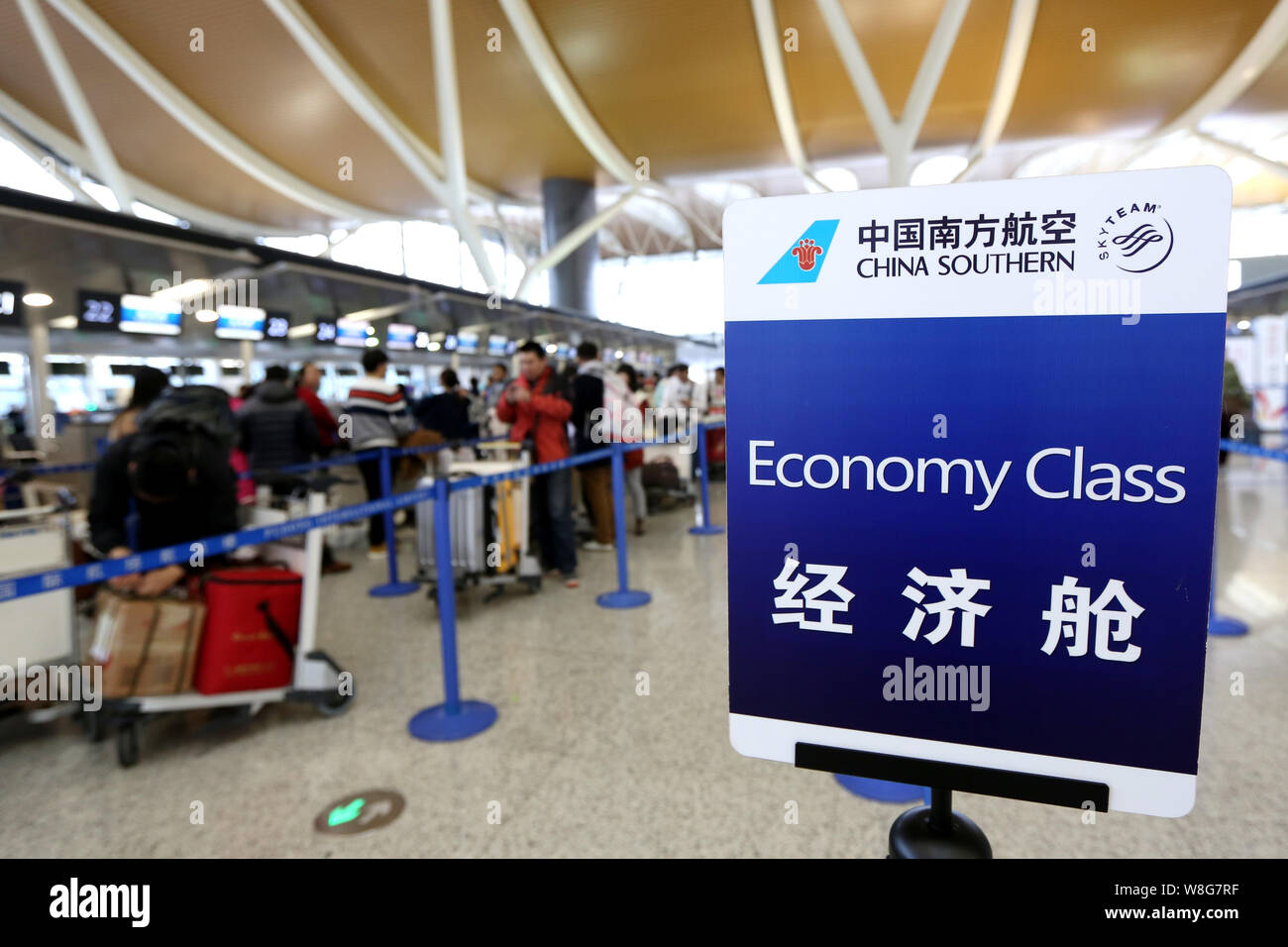 FILE&ndash;Passengers queue up to check in at the counters of China 
