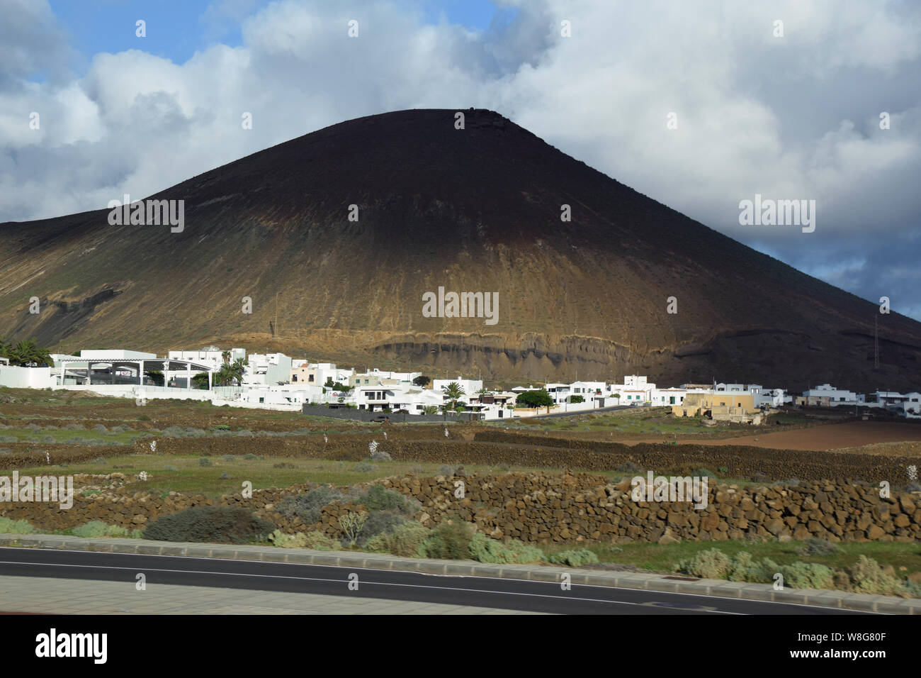 Village at the base of a volcano, Lanzarote, Canary Islands, Spain Stock Photo