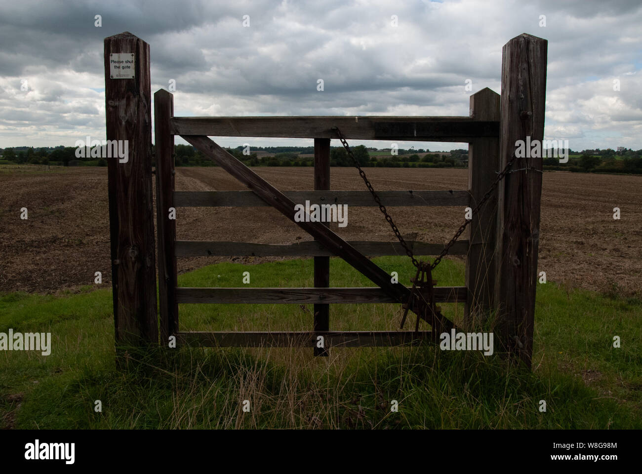 A closed gate in the middle of a field in the middle of England UK. Closed to those only who think that way Stock Photo