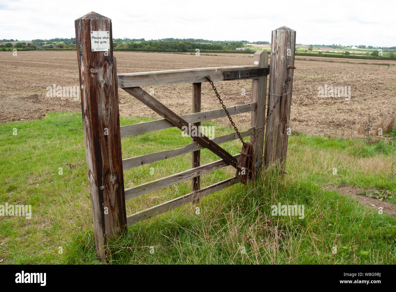 A closed gate in the middle of a field in the middle of England UK. Closed to those only who think that way Stock Photo