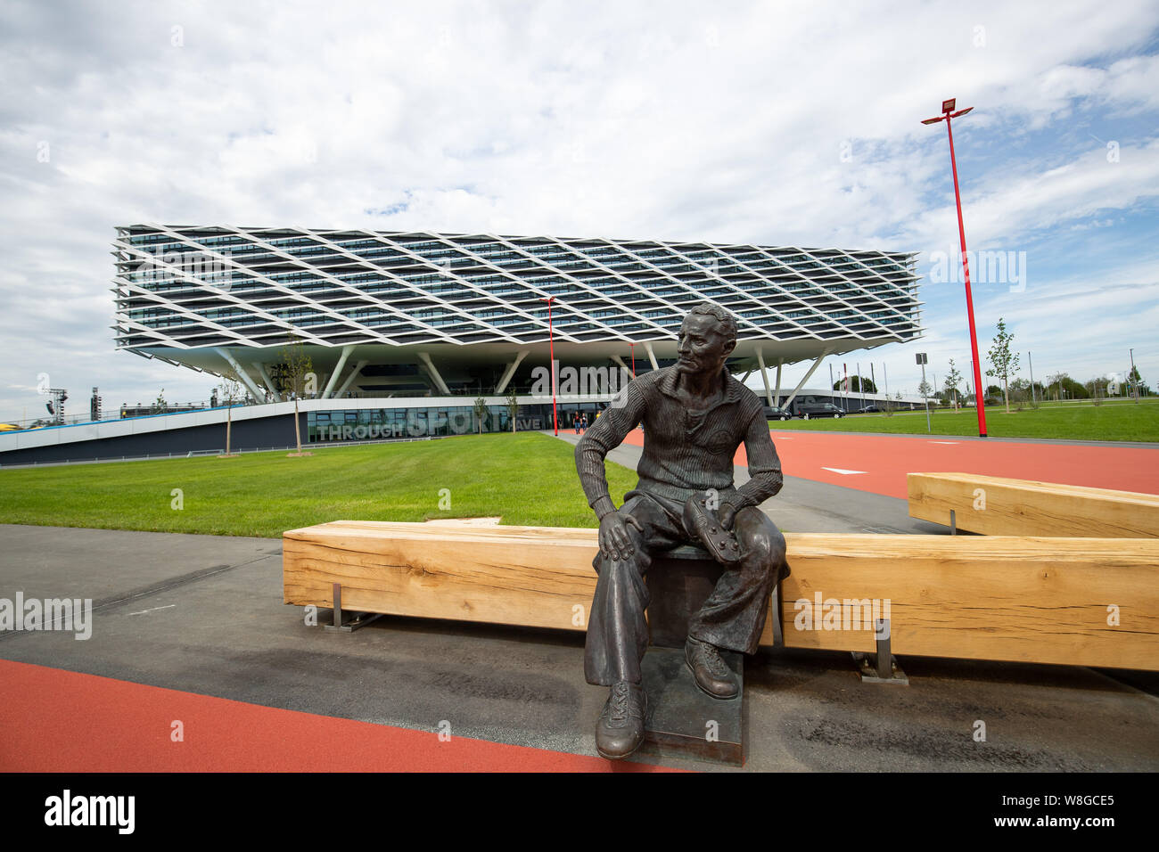 Herzogenaurach, Germany. 09th Aug, 2019. A statue of the founder Adolf  "Adi" Dassler is placed in front of the new office building "Arena" of the  sporting goods manufacturer adidas. Shortly before its