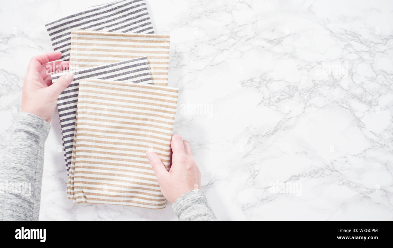 Flat lay. Folding kitchen towels on a marble countertop Stock Photo Alamy