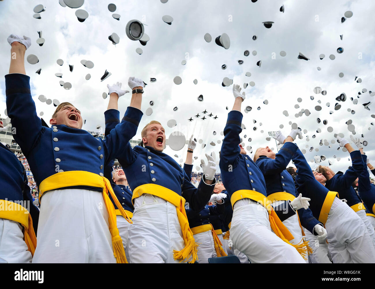 The U.S. Air Force Academy’s Class of 2015 tosses their hats in celebration as the Thunderbirds roar over Falcon Stadium in Colorado Springs, Colo., M Stock Photo