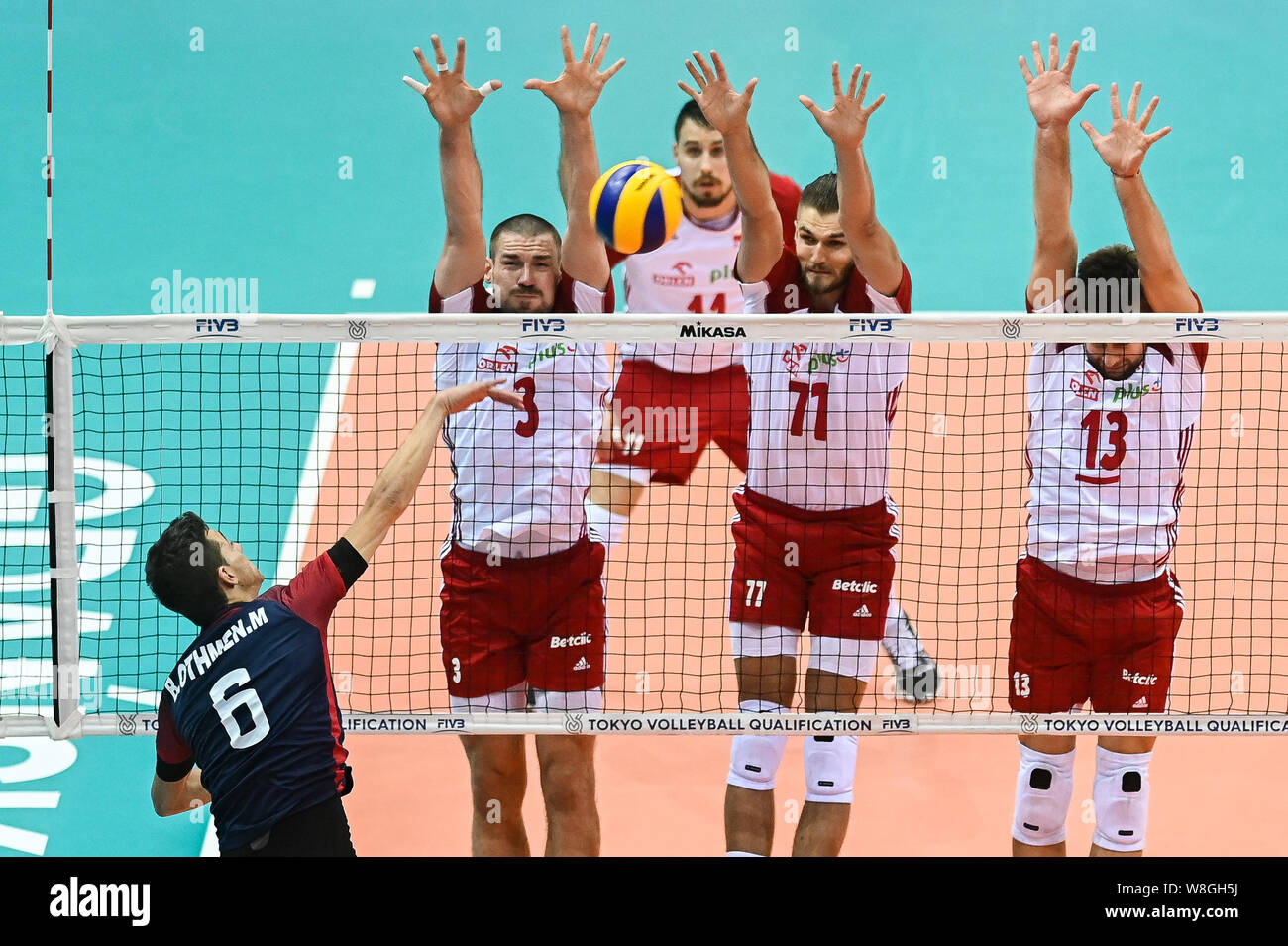Dawid Konarski (L) Karol Klos (C) and Michal Kubiak (R) from Poland are seen in action during Men's Olympics Qualifiers Tournament Pool D match between Poland and Tunisia.(Poland beat Tunisia : 3-0) Stock Photo