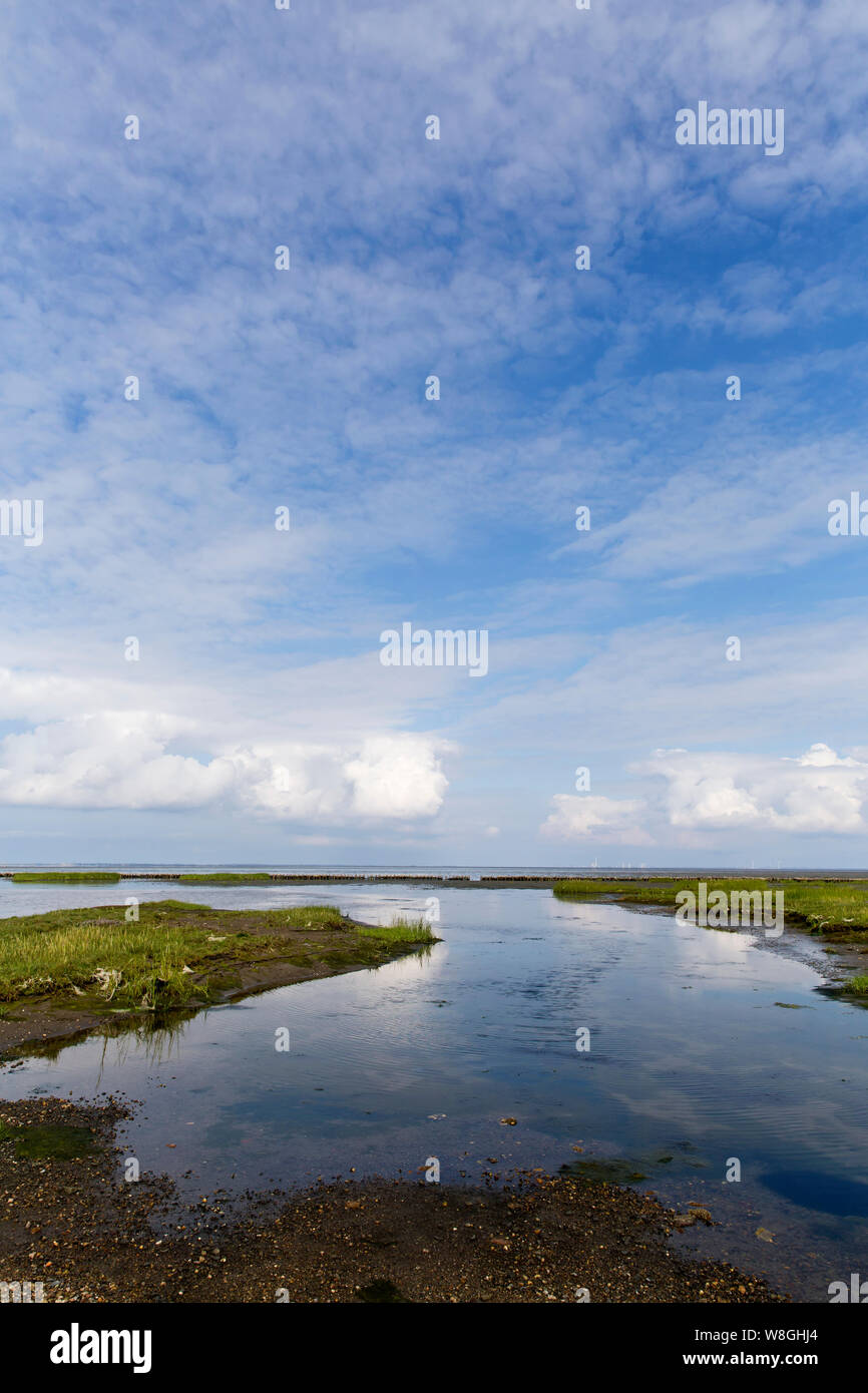 A view to the Watten Sea as seen from the gravel road which connect the island Mandø with the Danish mainland on the south western coast of Denmark. Stock Photo