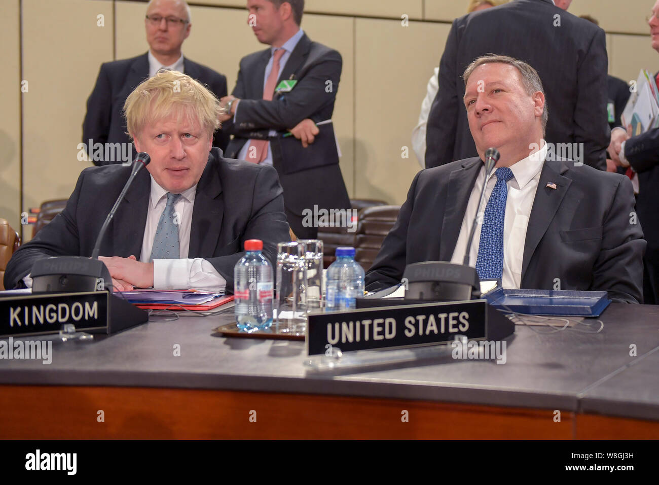 U.S. Secretary of State Mike Pompeo and UK Foreign Secretary Boris Johnson listen during a meeting of NATO Foreign Ministers in Brussels, Belgium, on Stock Photo