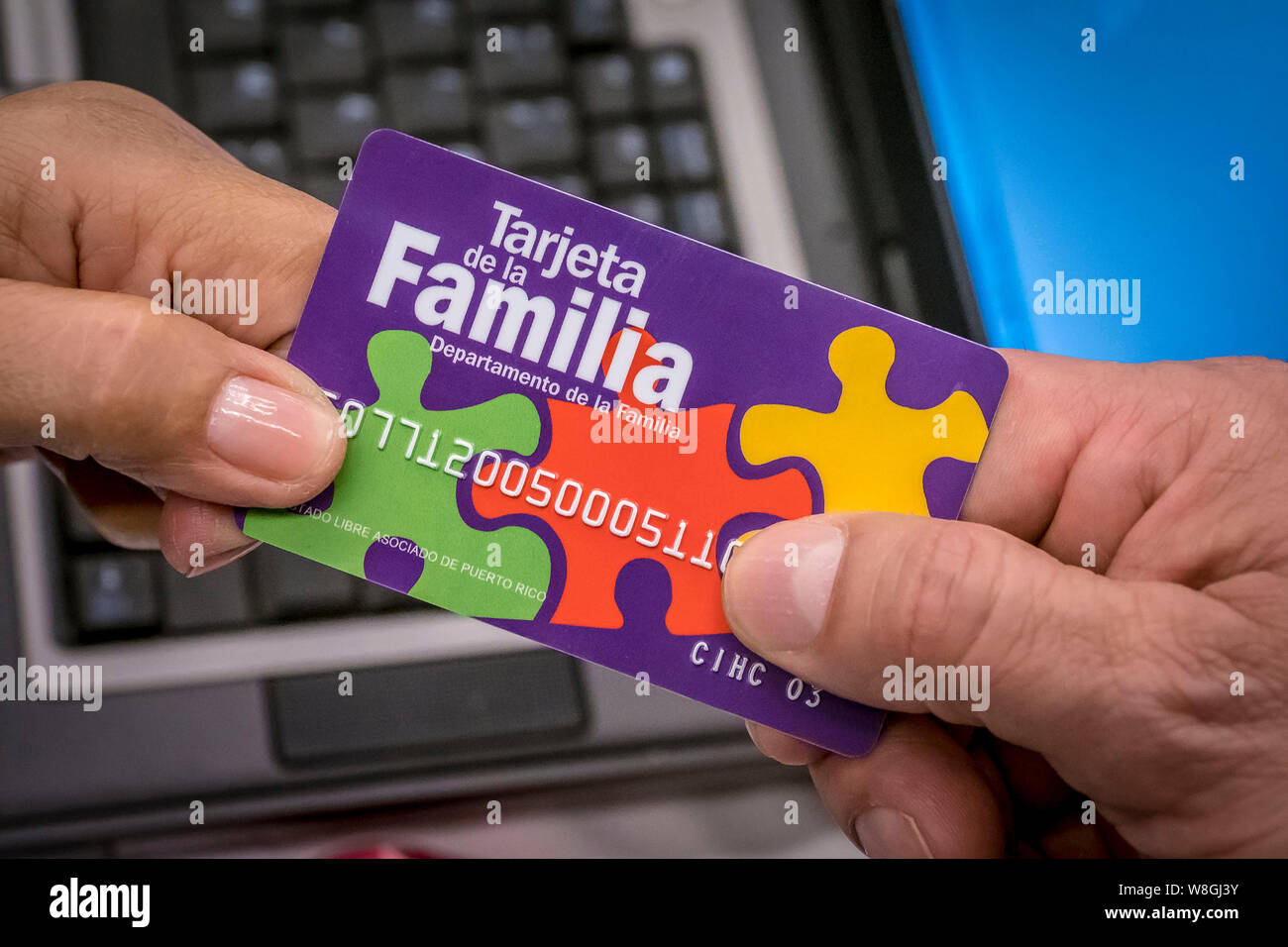 A resident in Puerto Rico receives a benefit card to help them recover after Hurricane Maria on March 22, 2018 Stock Photo