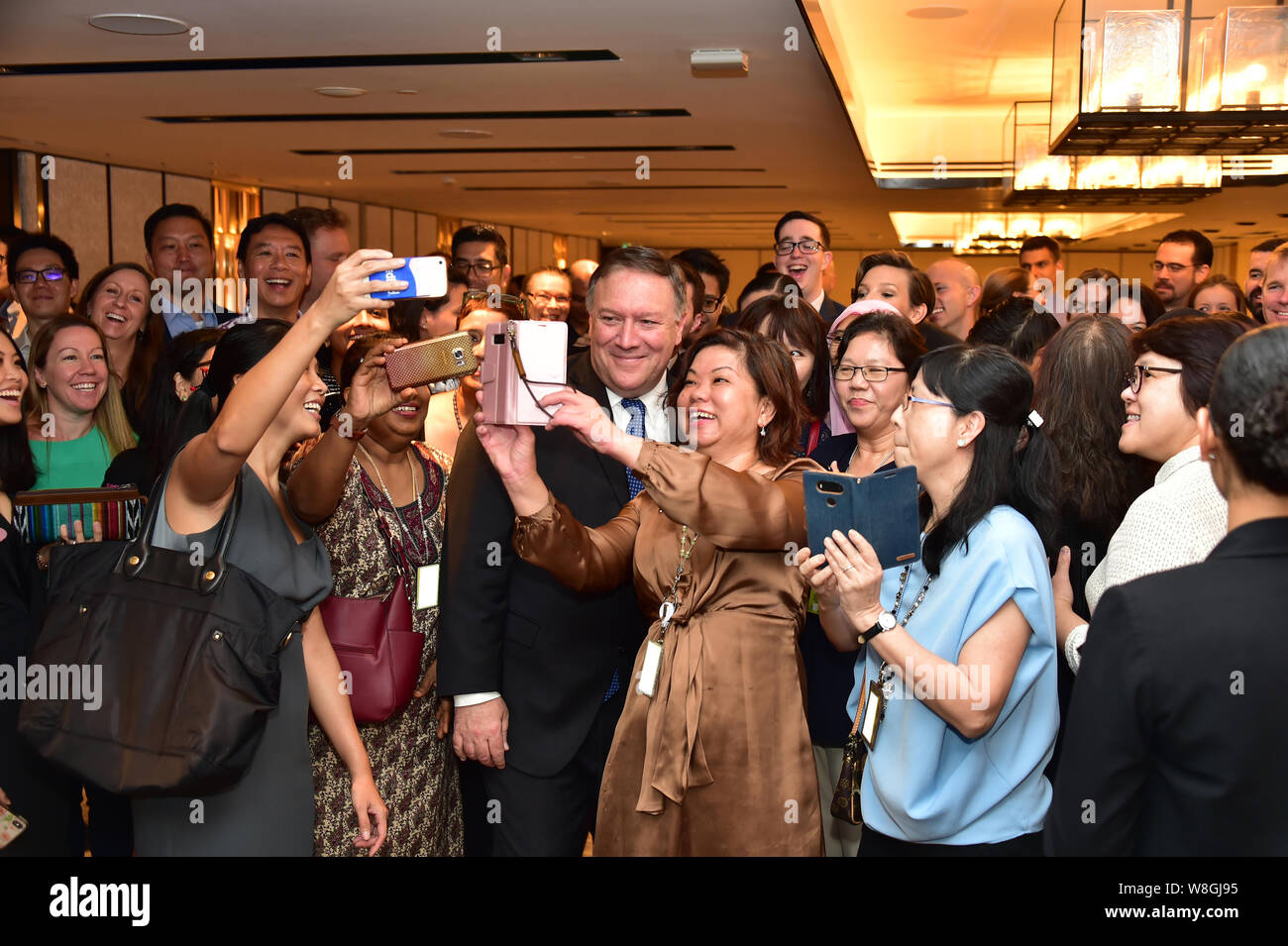 U.S. Secretary of State Mike Pompeo poses for a photograph with U.S. Embassy Singapore staff and colleagues from around the region who supported the S Stock Photo