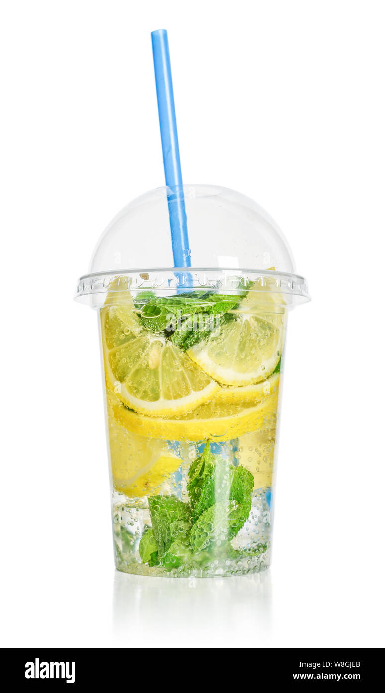 Lemonade with lemon and  mint in a plastic cup with drink straw isolated on white background. Take away drinks concept. Stock Photo