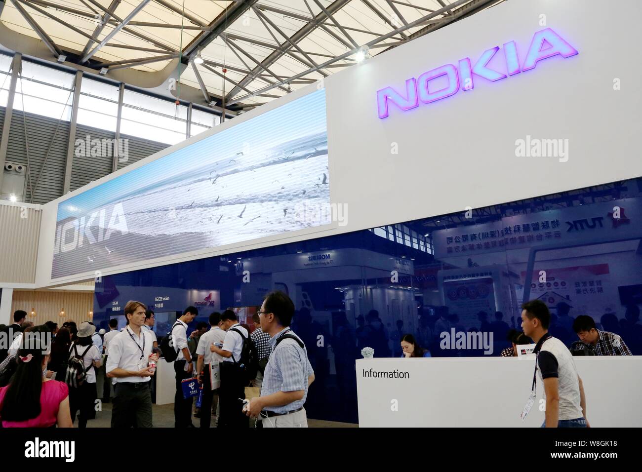 People visit the stand of Nokia during the GSMA Mobile World Congress 2015 in Shanghai, China, 15 July 2015. Stock Photo