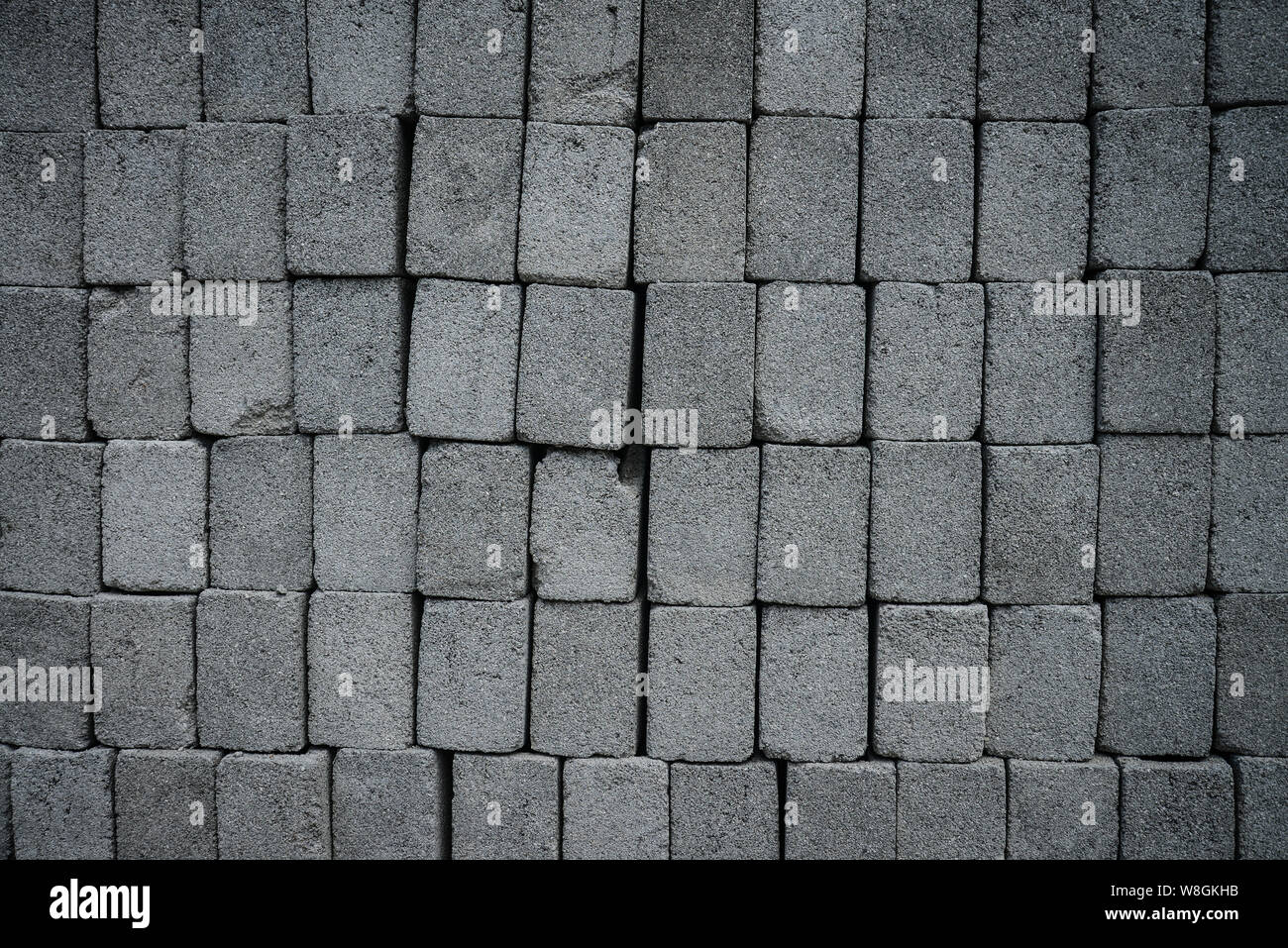 Stack of gray construction bricks closeup. May be used as background Stock Photo