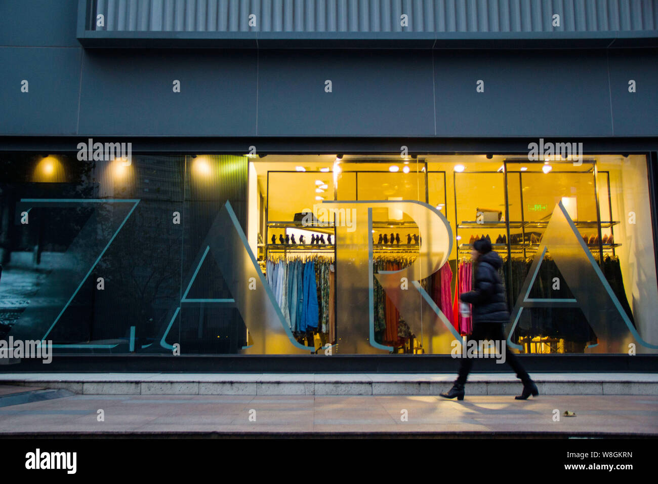 FILE--A pedestrian walks past a store of Zara in Shanghai, China, 26  December 2013. Prada had 33 stores in China in the first quarter of this  Stock Photo - Alamy