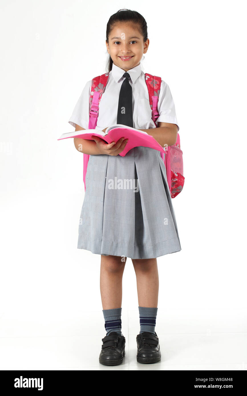 Schoolgirl reading a book Stock Photo - Alamy