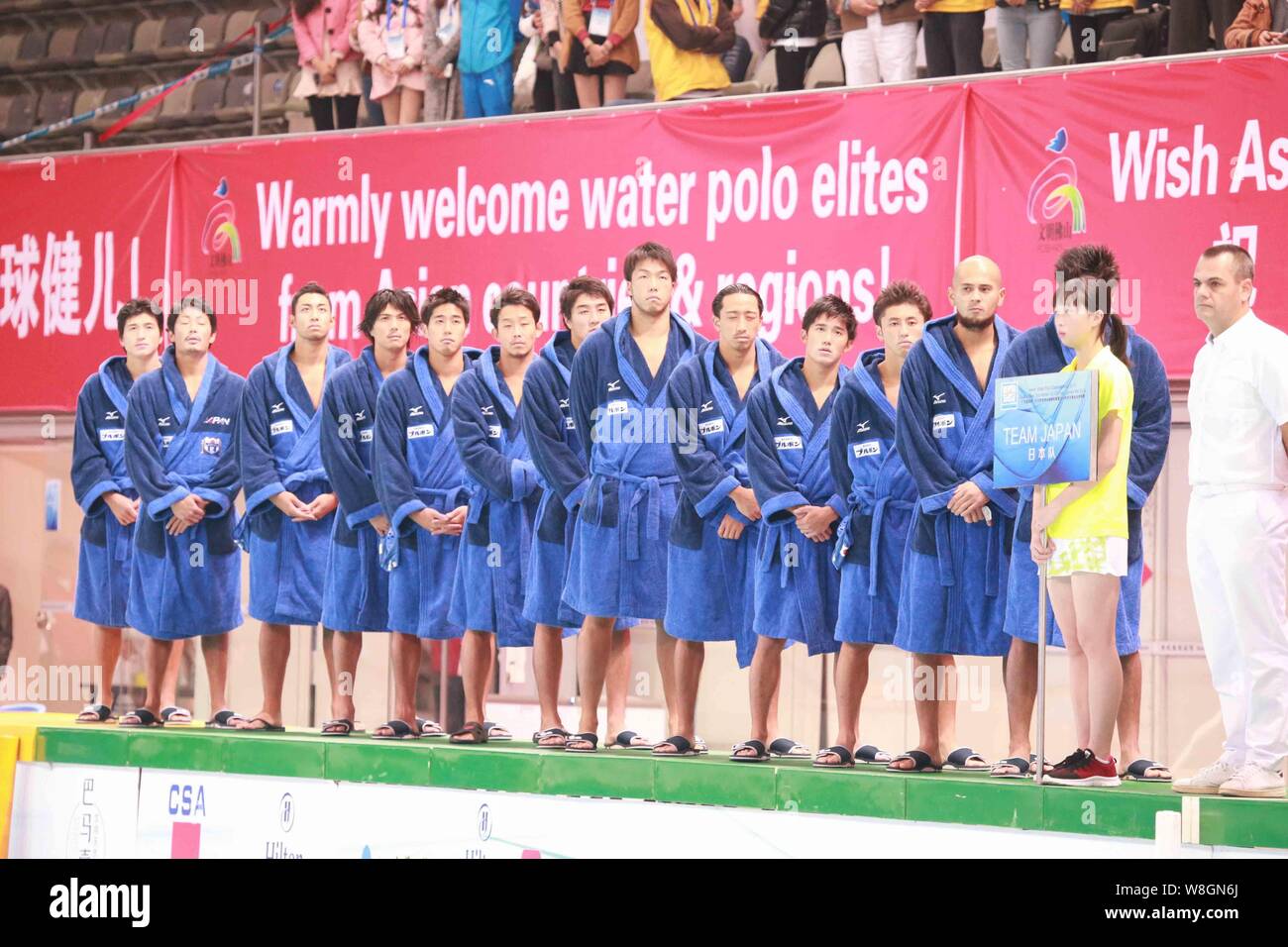Players of Japan men's national water polo team pose on the podium after defeating China men's