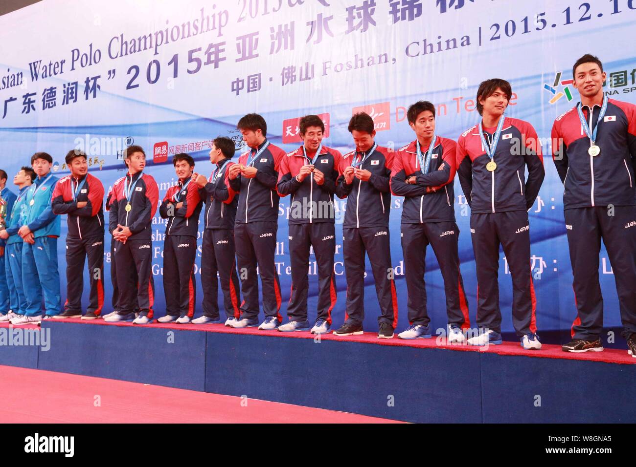 Players of Japan men's national water polo team pose on the podium with China men's national