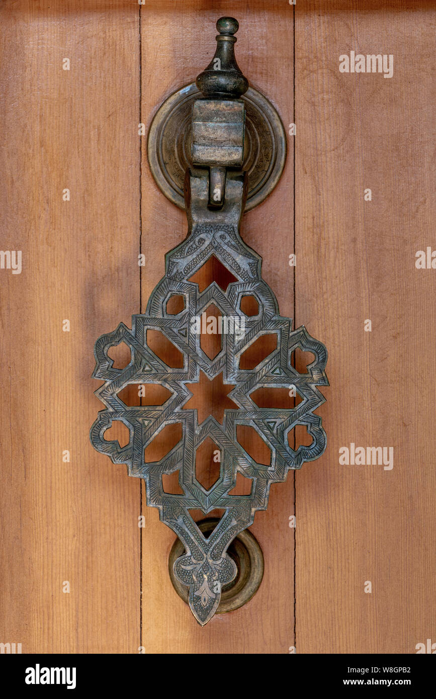 Elaborate ancient brass doorknocker with filigree details Stock Photo