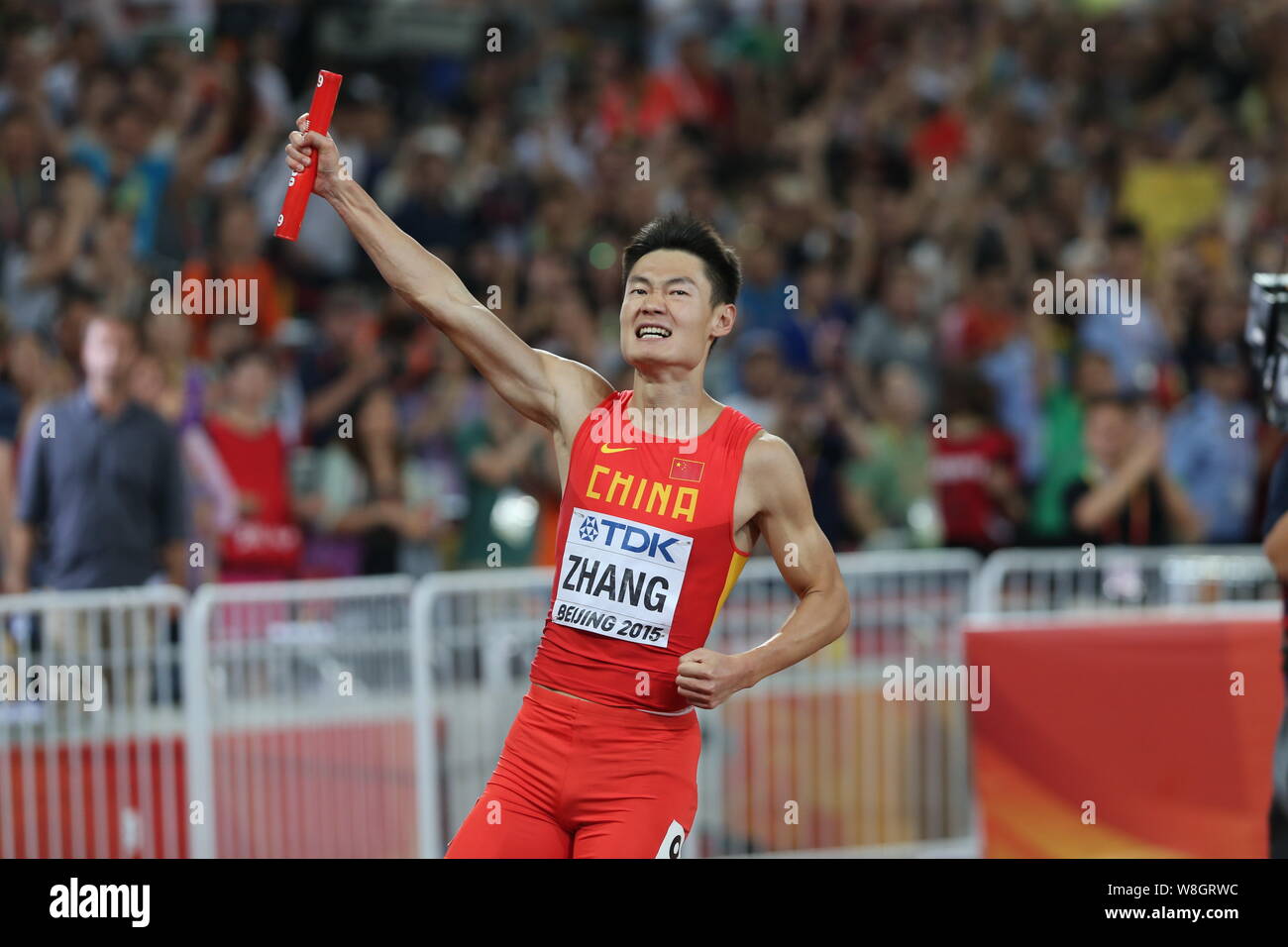 Zhang Peimeng of China's men's 4x100m relay team celebrates after winning the runner-up of the men's 4x100m relay final during the Beijing 2015 IAAF W Stock Photo