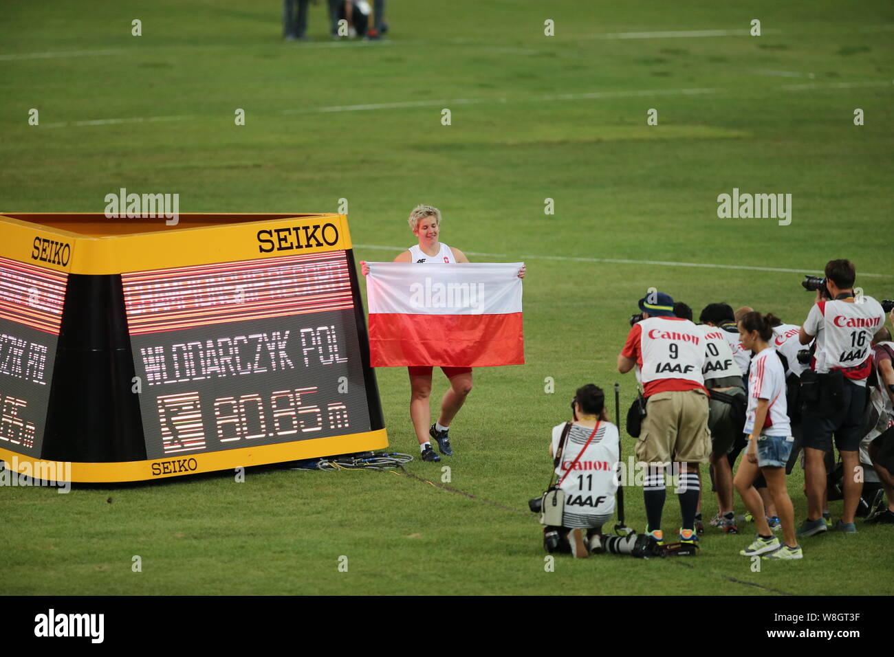 Poland's Anita Wlodarczyk, left, poses for photos after winning the