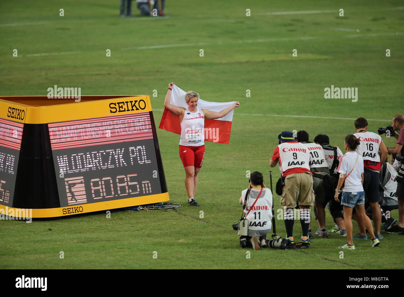 Poland's Anita Wlodarczyk, left, poses for photos after winning the