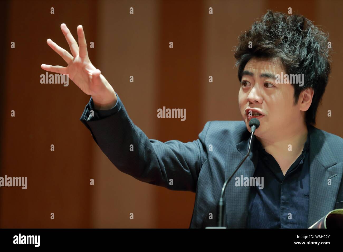 Chinese pianist Lang Lang speaks at a press conference for his new book 'Lang Lang Piano Academy: Mastering the Piano' in Shanghai, China, 23 January Stock Photo