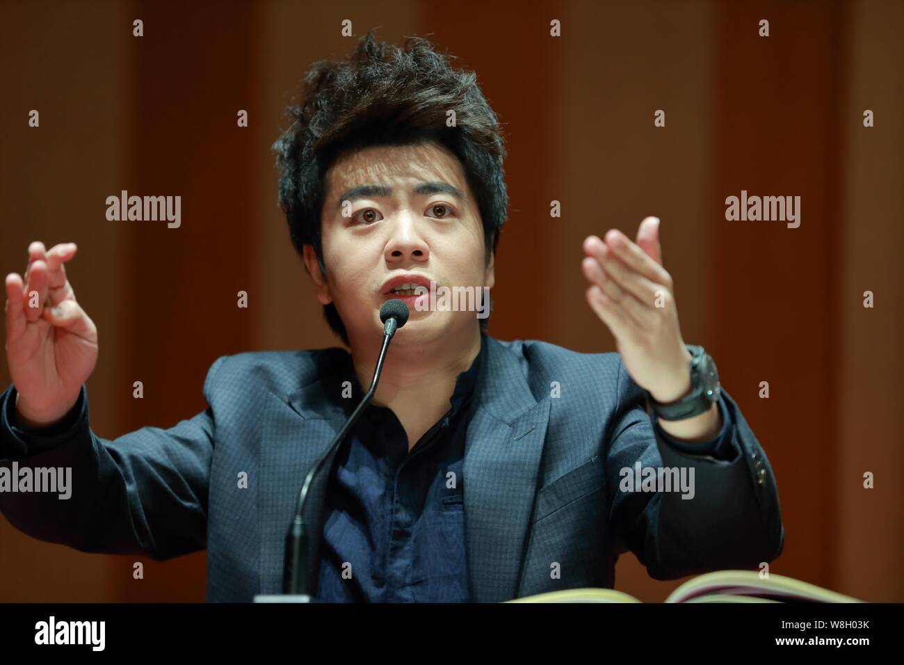 Chinese pianist Lang Lang speaks at a press conference for his new book 'Lang Lang Piano Academy: Mastering the Piano' in Shanghai, China, 23 January Stock Photo