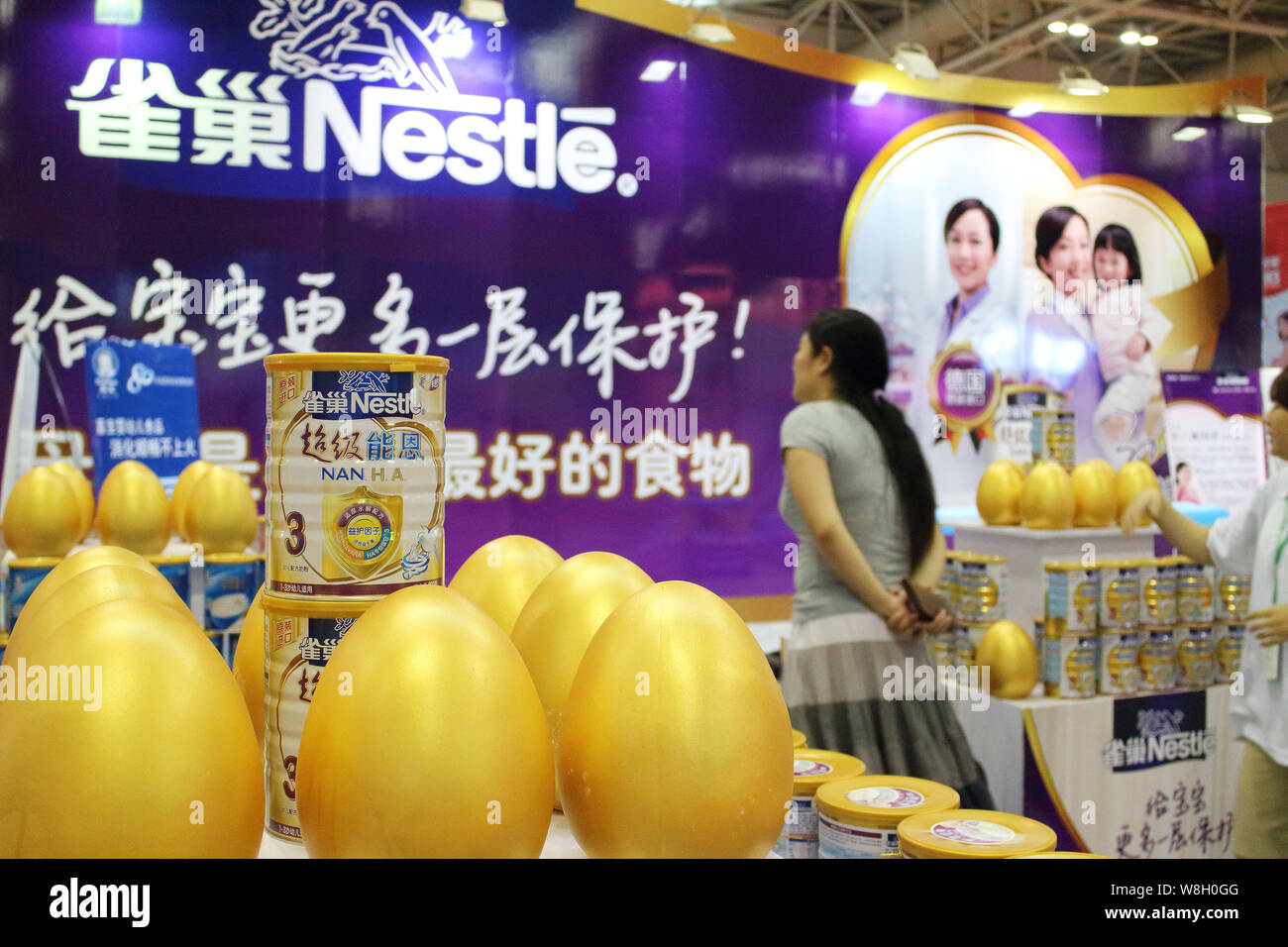 --FILE--A visitor is seen at the stand of Nestle during an exhibition in Fuzhou city, southeast China's Fujian province, 30 May 2014.   Swiss firm Nes Stock Photo