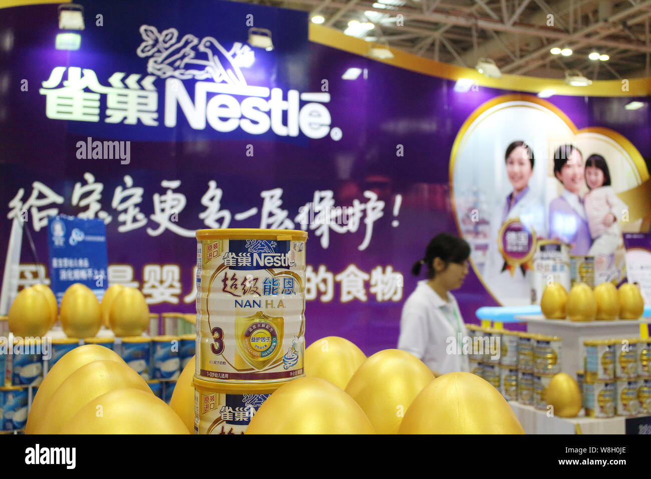 --FILE--A visitor looks at Nestle baby formula during an exhibition in Fuzhou city, southeast China's Fujian province, 30 May 2014.   Nestle SA on Thu Stock Photo