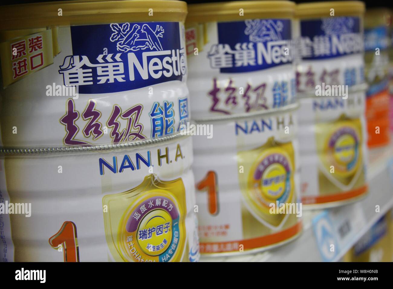 --FILE--Tins of Nestle milk powder are for sale at a supermarket in Nantong city, east China's Jiangsu province, 6 July 2013.   Swiss firm Nestle, the Stock Photo