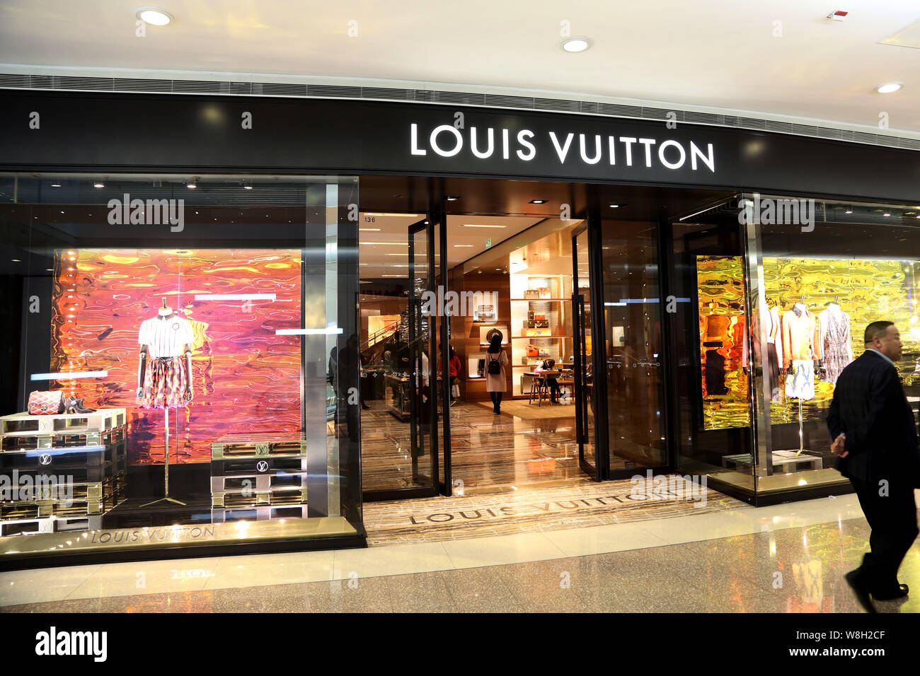 A pedestrian walks past a Louis Vuitton (LV) boutique of LVMH Moet Hennessy Louis  Vuitton SA at a shopping mall in Shanghai, China, 20 March 2015 Stock Photo  - Alamy