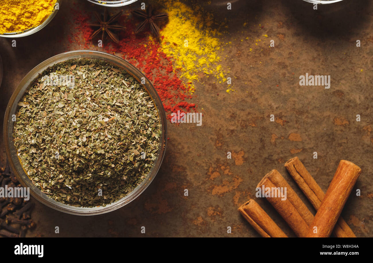 Dried Marjoram . Place for text. Different types of Spices in a bowl on