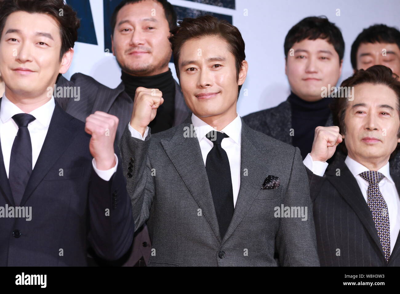 South Korean actors Cho Seung-woo, Lee Byung-hun and Baek Yoon-sik pose as they arrive for a VIP screening event of their new movie 'Inside Men' in Se Stock Photo