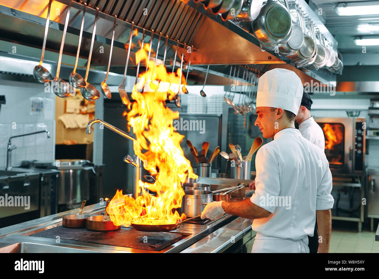 Modern kitchen. Cooks prepare meals on the stove in the kitchen of the