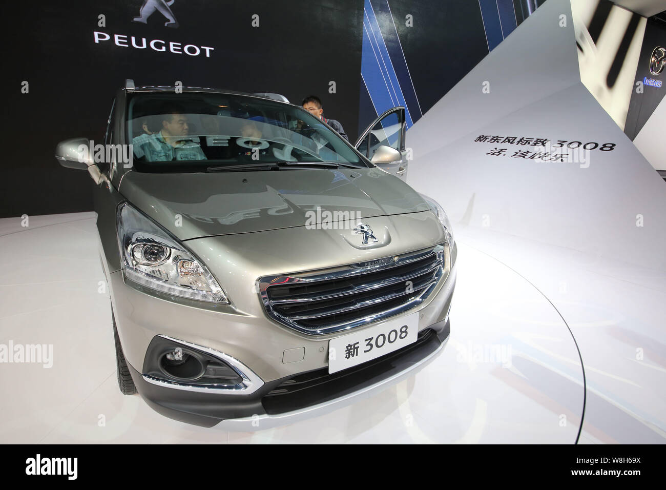 FILE--Visitors try out a New 3008 of Dongfeng Peugeot Citroen during the  12th China (Guangzhou) International Automobile Exhibition, known as Auto G  Stock Photo - Alamy