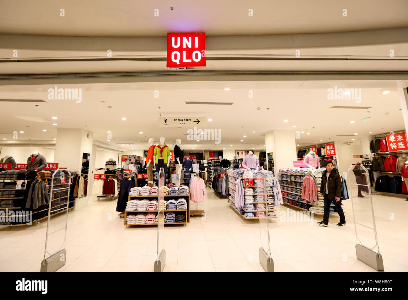 FILE--Customers shop at a store of Uniqlo in Shanghai, China, 16 January  2015. International fast-fashion brands continue their aggressive expansi  Stock Photo - Alamy
