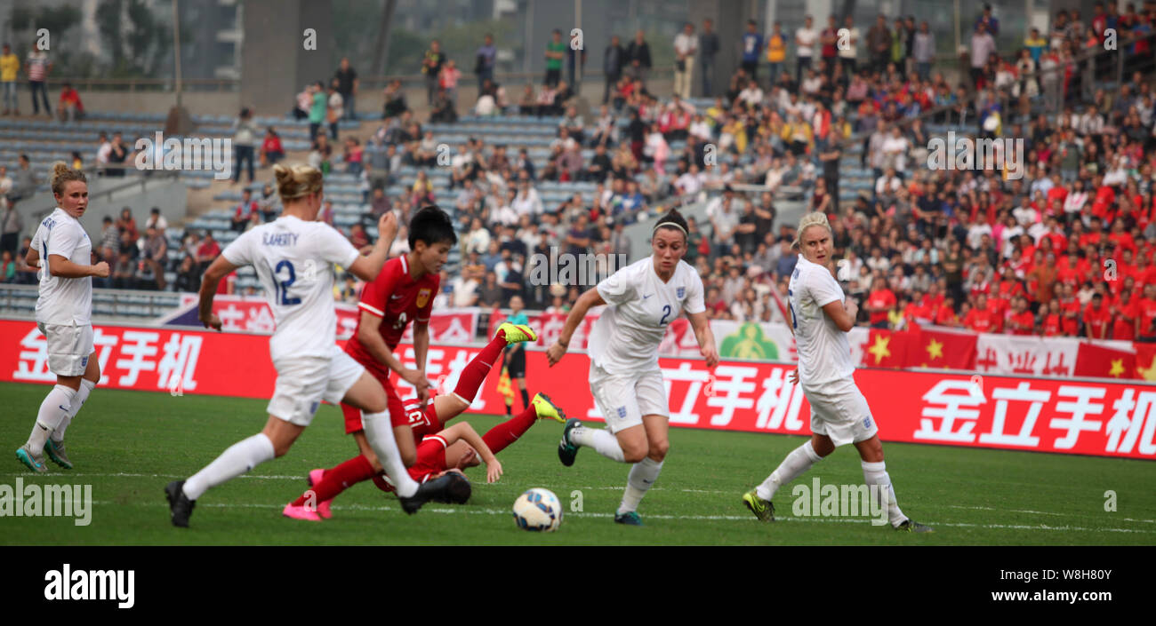 Wang Shanshan of China, second left, dribbles against players of England in the opening match of the Dewellbon Cup CFA International Women's Football Stock Photo