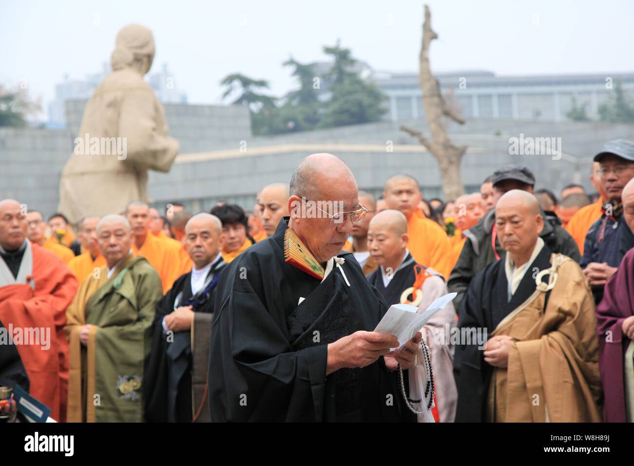 Japanese monk Yoshio Hasegawa, front, chants scriptures during a memorial to mourn for the victims of the Nanjing Massacre at the Museum of Victims in Stock Photo
