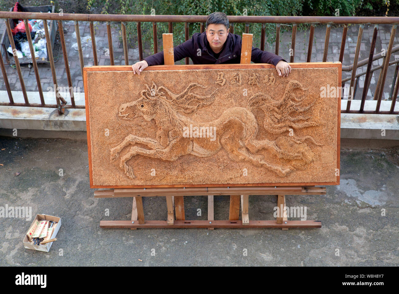 38-year-old Liu Xuedong poses with his toothpick-made 3D horse painting ...