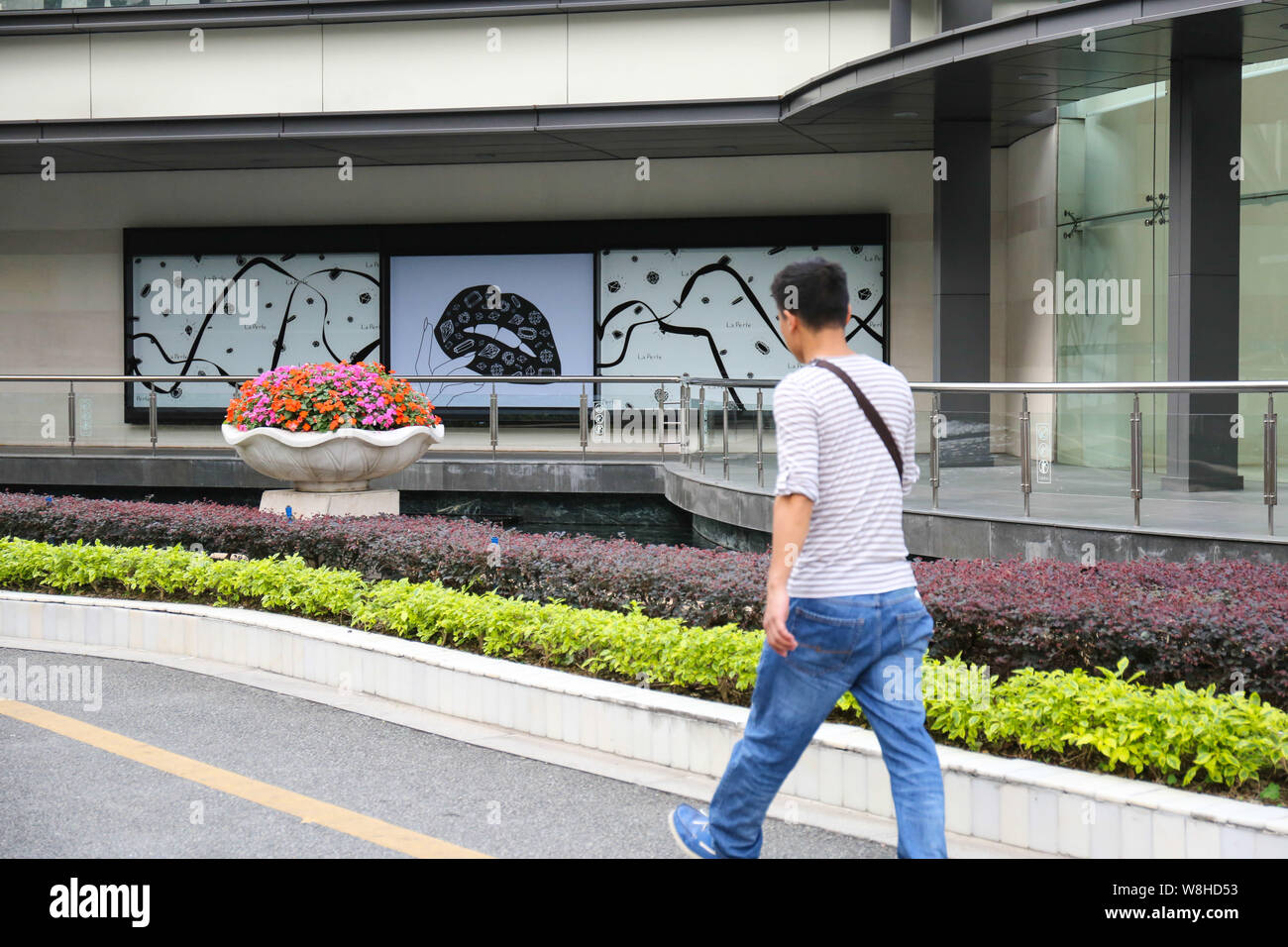 A pedestrian walks past the closed store of Louis Vuitton (LV) in the La Perle shopping mall in Guangzhou city, south China's Guangdong province, 20 N Stock Photo