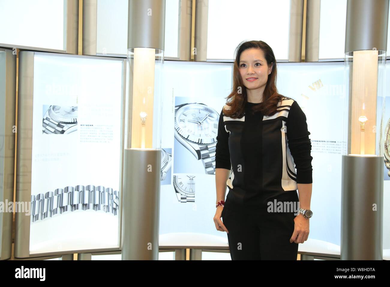 Retired Chinese tennis star Li Na poses during a promotional event for Rolex watch in Hangzhou city, east China's Zhejiang province, 17 October 2015. Stock Photo