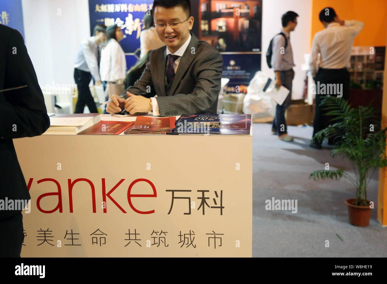 FILEA Chinese employee is seen at the stand of Vanke during a real