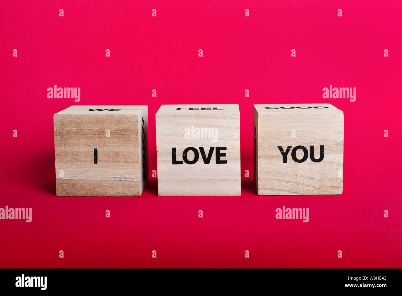 Message 'I love you spelled' in wooden blocks on pink background Stock Photo
